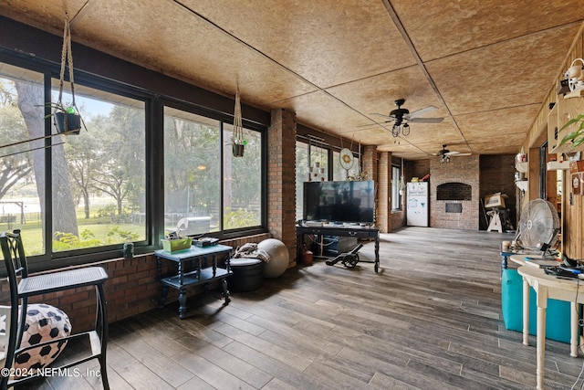 sunroom featuring a healthy amount of sunlight and ceiling fan