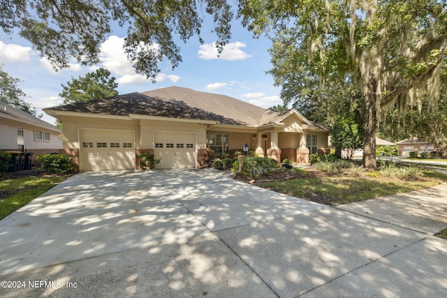 view of front of property featuring a garage and central air condition unit