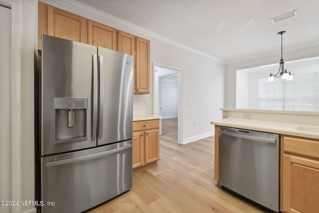 kitchen featuring appliances with stainless steel finishes, hanging light fixtures, light wood-type flooring, ornamental molding, and a notable chandelier