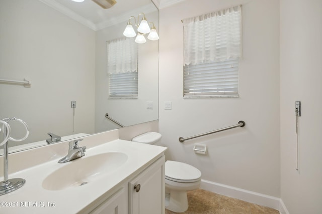 bathroom with ornamental molding, vanity, and toilet