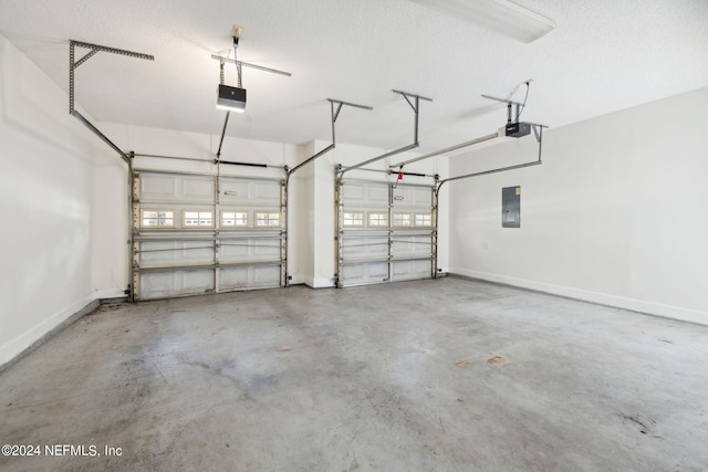 garage with a garage door opener and electric panel