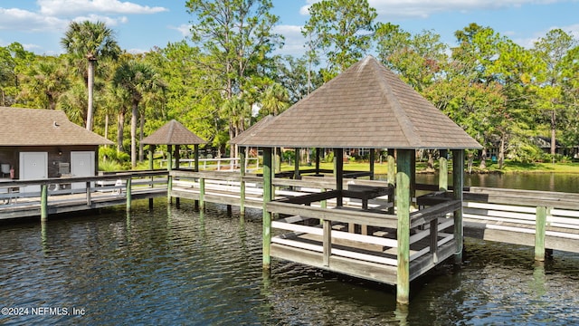 view of dock with a gazebo and a water view