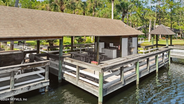 view of dock featuring a gazebo and a water view