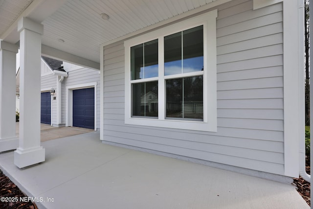 view of patio with a garage and covered porch