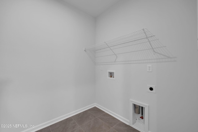 laundry room featuring washer hookup, hookup for an electric dryer, dark tile patterned flooring, laundry area, and baseboards