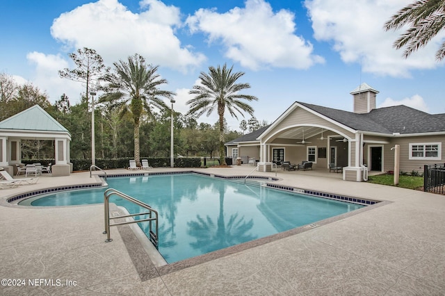 view of pool with ceiling fan and a patio area