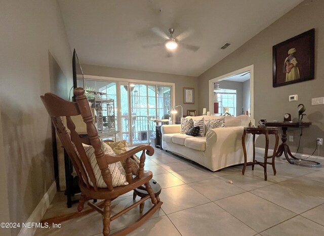 tiled living room featuring lofted ceiling and ceiling fan