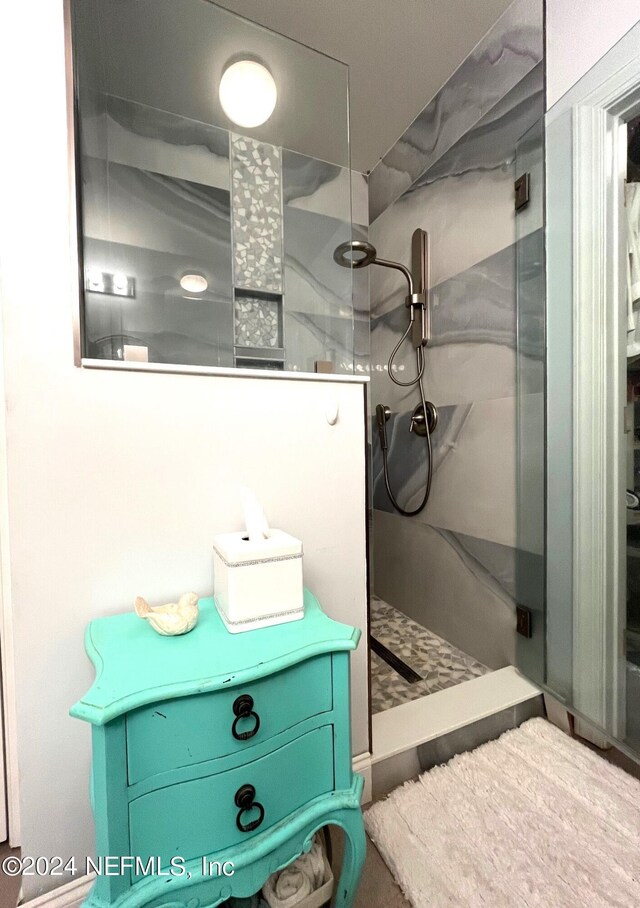 bathroom with walk in shower and vanity