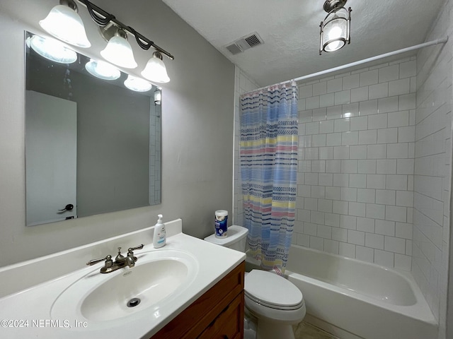 full bathroom with vanity, shower / bath combo, a textured ceiling, and toilet