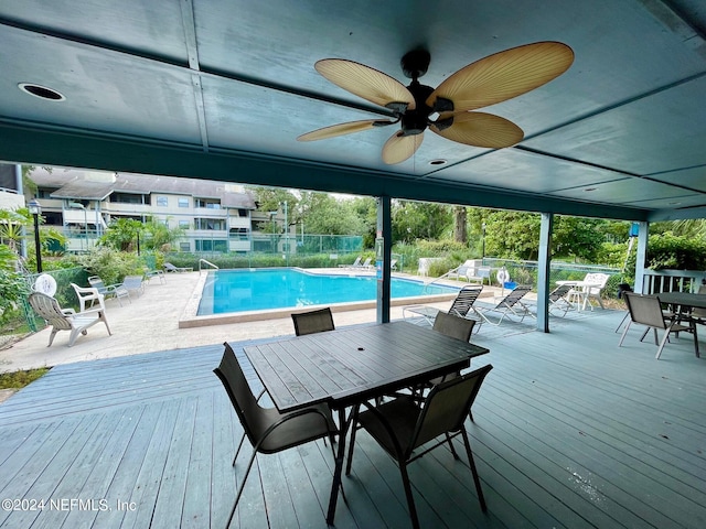 view of pool featuring a deck and ceiling fan