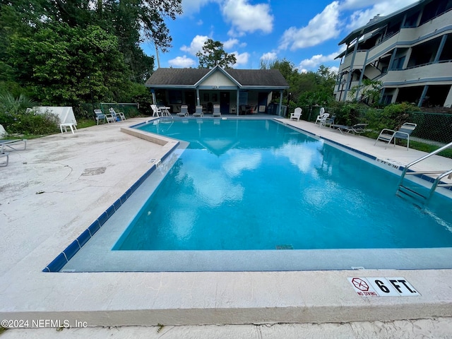 view of swimming pool featuring a patio area