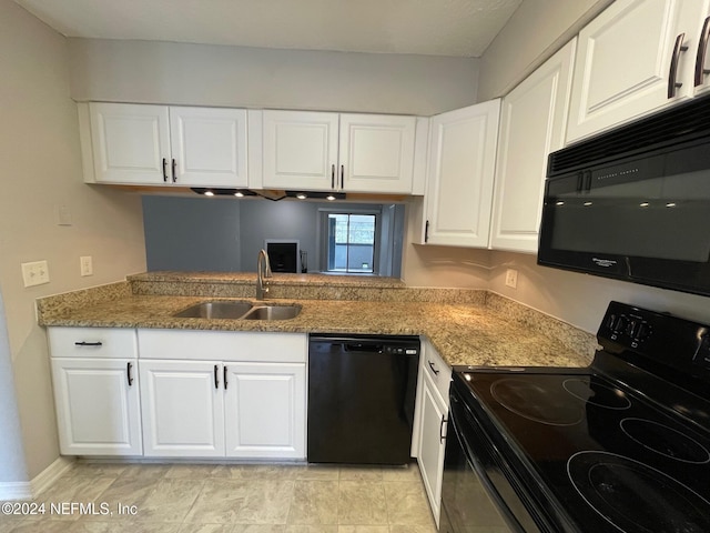 kitchen featuring sink, white cabinets, and black appliances