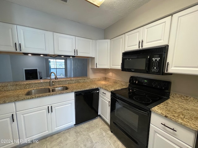 kitchen featuring a textured ceiling, sink, white cabinetry, and black appliances