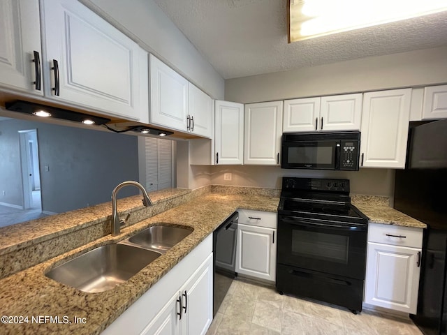 kitchen with sink, kitchen peninsula, a textured ceiling, white cabinets, and black appliances