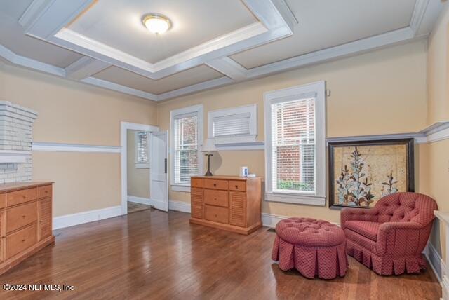 living area featuring coffered ceiling and dark hardwood / wood-style floors