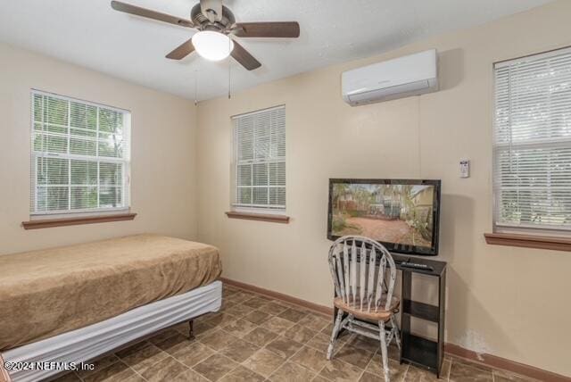 bedroom featuring ceiling fan and a wall mounted air conditioner