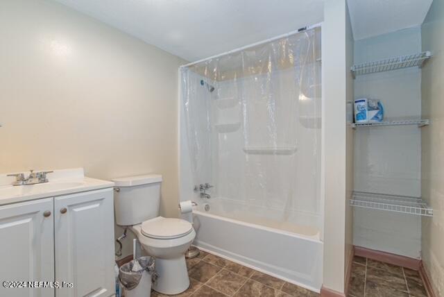 full bathroom with vanity, toilet, and shower / bath combination with curtain