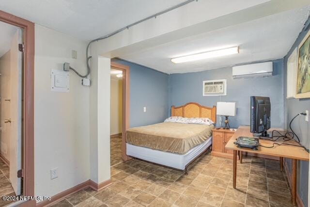 bedroom with an AC wall unit