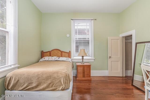 bedroom featuring dark wood-type flooring