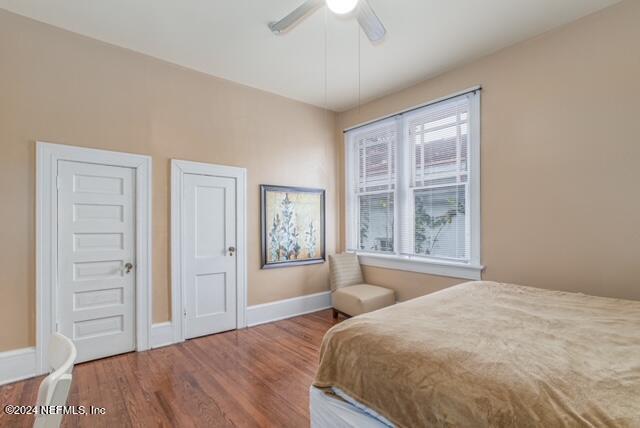 bedroom with wood-type flooring and ceiling fan