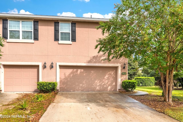 multi unit property featuring a garage