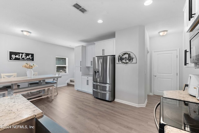 kitchen featuring light hardwood / wood-style flooring, stainless steel appliances, and white cabinets