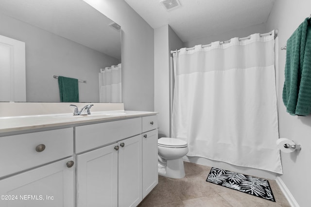 bathroom with walk in shower, vanity, toilet, and a textured ceiling