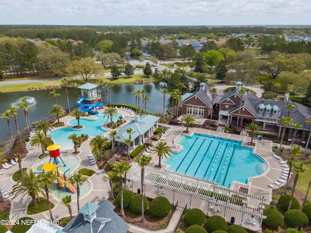 view of swimming pool with a water slide, a water view, and a patio