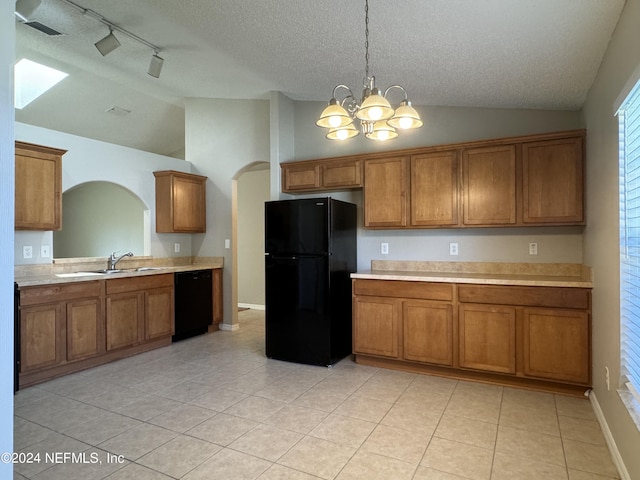 kitchen with vaulted ceiling, black appliances, a sink, and brown cabinetry