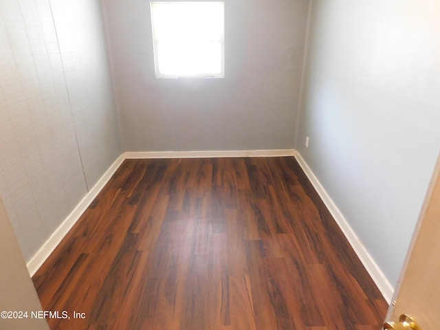 spare room with dark wood-type flooring