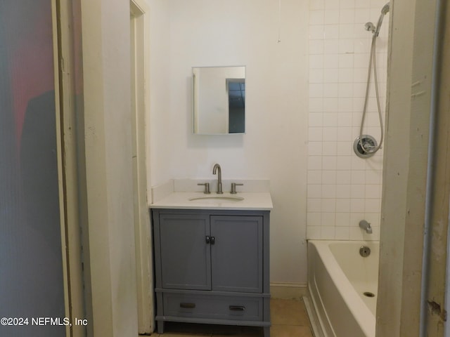 bathroom featuring tiled shower / bath combo, tile patterned flooring, and vanity