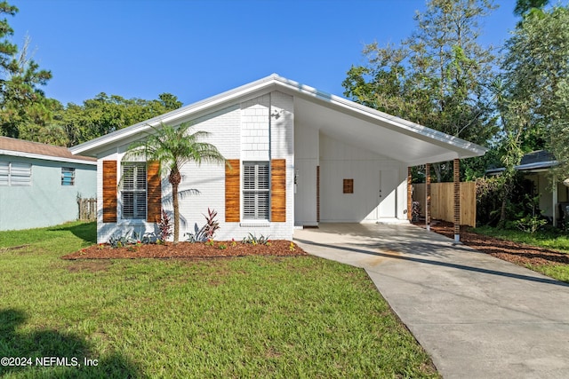 view of front facade with a front lawn and a carport