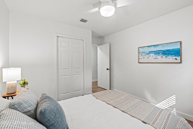 bedroom with a closet, ceiling fan, and hardwood / wood-style flooring