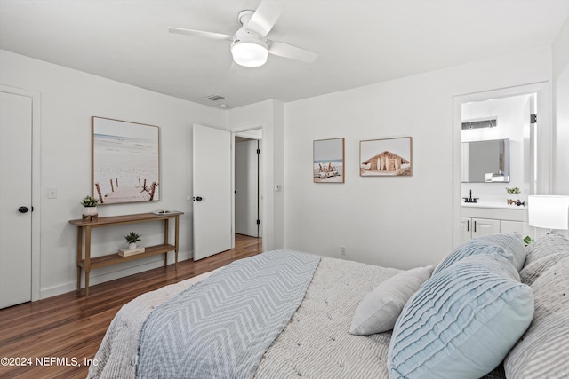 bedroom featuring connected bathroom, ceiling fan, and dark wood-type flooring