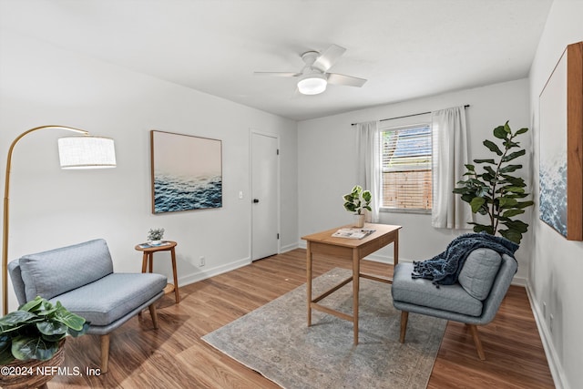 living area featuring ceiling fan and light hardwood / wood-style flooring