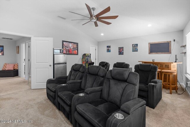 carpeted home theater room with ceiling fan and lofted ceiling