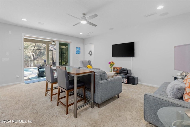 living room featuring ceiling fan and light colored carpet