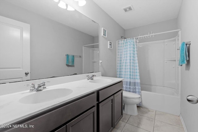 full bathroom with vanity, shower / bath combo with shower curtain, toilet, and tile patterned floors