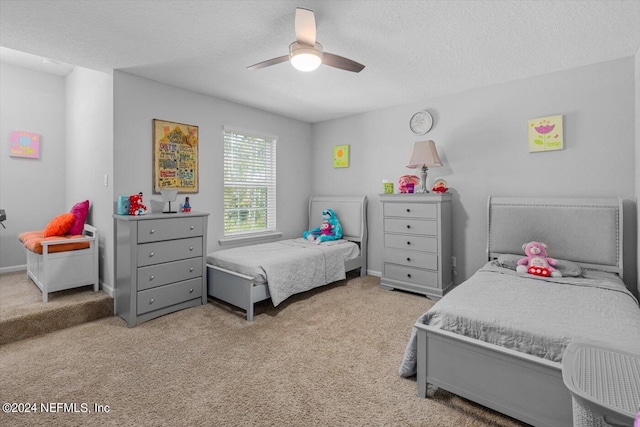 carpeted bedroom with a textured ceiling and ceiling fan