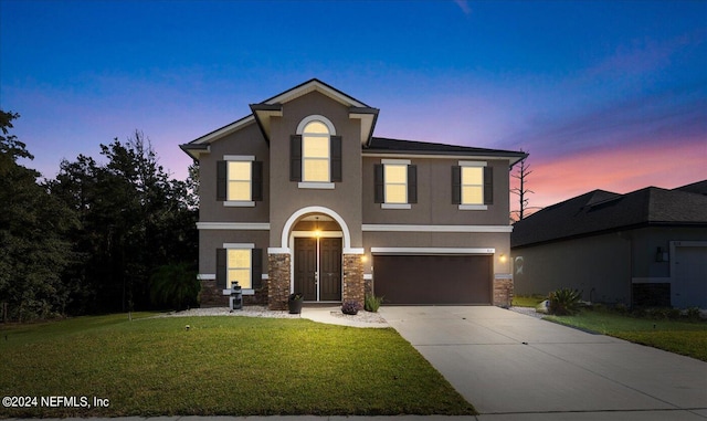 view of front property with a lawn and a garage