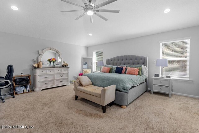 bedroom with ceiling fan and light carpet