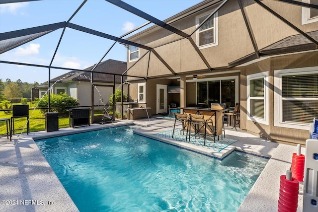 view of pool with a patio and a lanai