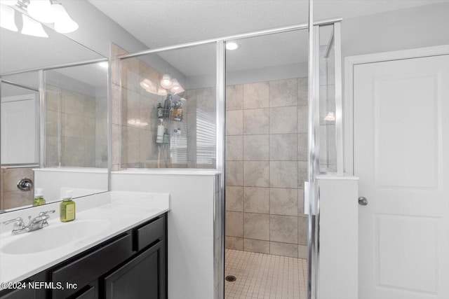 bathroom with walk in shower and vanity