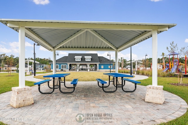 view of property's community featuring a playground, a gazebo, and a yard