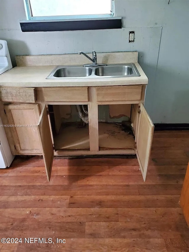 kitchen featuring light brown cabinets, hardwood / wood-style flooring, and sink