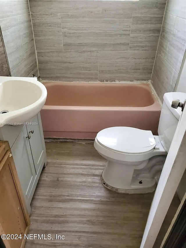 bathroom with hardwood / wood-style floors, vanity, and toilet