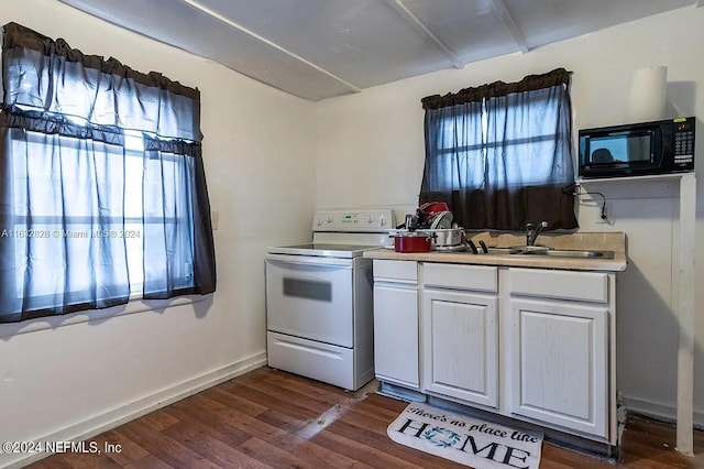 kitchen featuring white cabinets, dark wood-type flooring, white electric stove, and a wealth of natural light