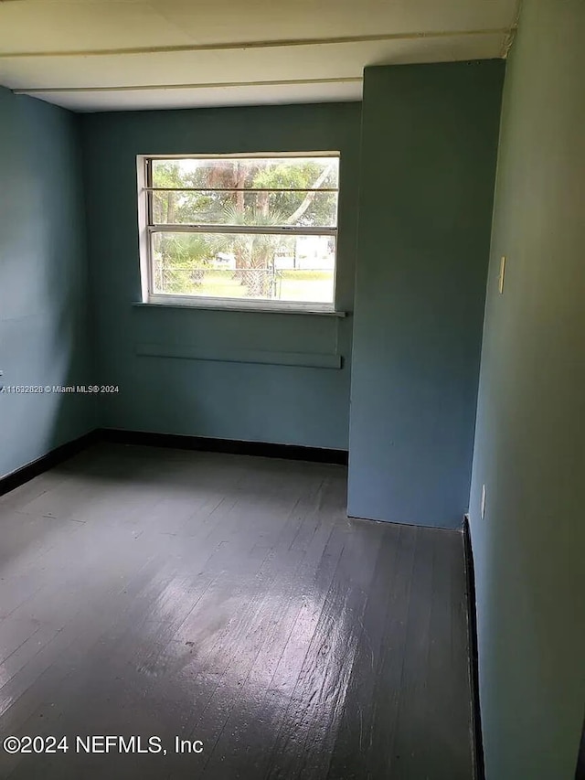 unfurnished room featuring hardwood / wood-style flooring