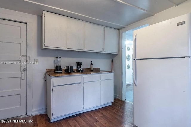 kitchen featuring white cabinets, white refrigerator, and dark hardwood / wood-style floors