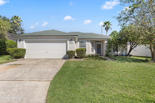 view of front of house with a garage and a front lawn